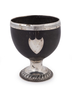 A Georgian silver mounted coconut bowl with gadrooned silver base and shield plaque, 18th/19th century, 12.5cm high