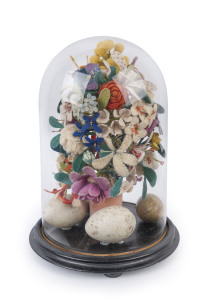 An antique wool work and birds egg floral display in glass dome on ebonized base, 19th century, 40cm high