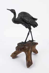 A Japanese silvered bronze crane statue by HIDENAO, Meiji period, ​on a polished wooden stand, signed on the underside, 43cm high overall