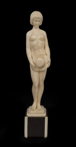 A French Art Deco statue of a nude with a hat, carved ivory and rosewood, circa 1925, signed "A. Migeon", 26.5cm high