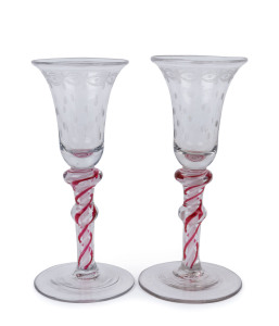 A rare pair of Georgian glasses, double air twist stems in red and white with wheel cut decoration to the bowls, 18th century, 15.5cm high