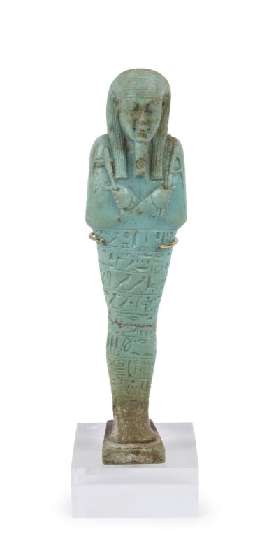 An Egyptian green faience shabti figure, circa 1st - 2nd Century AD, 15cm high