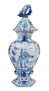 A Dutch DELFT tin glazed earthenware lidded urn, decorated with romantic scene and parrot finial, early 18th century, 38cm high