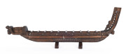 A Maori miniature canoe, carved wood and paua shell, New Zealand, 20th century, 101cm long