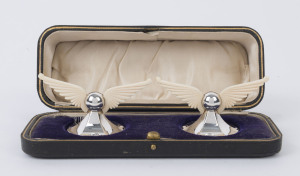 A pair of English sterling silver and ivory knife rests in original fitted box by James Dickson & Sons of Sheffield, circa 1910, 4.5cm high, 8cm wide
