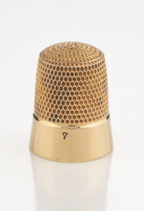 An antique American yellow gold thimble in original fitted leather case, circa 1905, stamped "14K", most likely by Gorhams, ​2cm high, 4.2 grams