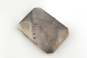 An antique Continental cigarette case studded with cabochon rubies, late 19th century, stamped "KRAFT ALPACCA" with pictorial maker's mark, 9.5 x 7cm