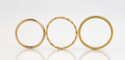 Three yellow gold rings, ​7 grams total