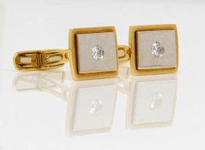 A pair of two tone 18ct yellow and white gold cufflinks set with diamonds, stamped "750", ​17 grams total