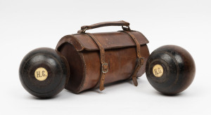 A pair of antique lawn bowls, lignum vitae inlaid with bone, in original leather case, 19th/20th century, ​the case 25cm wide