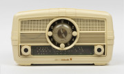 AWA mantel radio clock in ivory plastic case, ​19cm high, 35cm wide