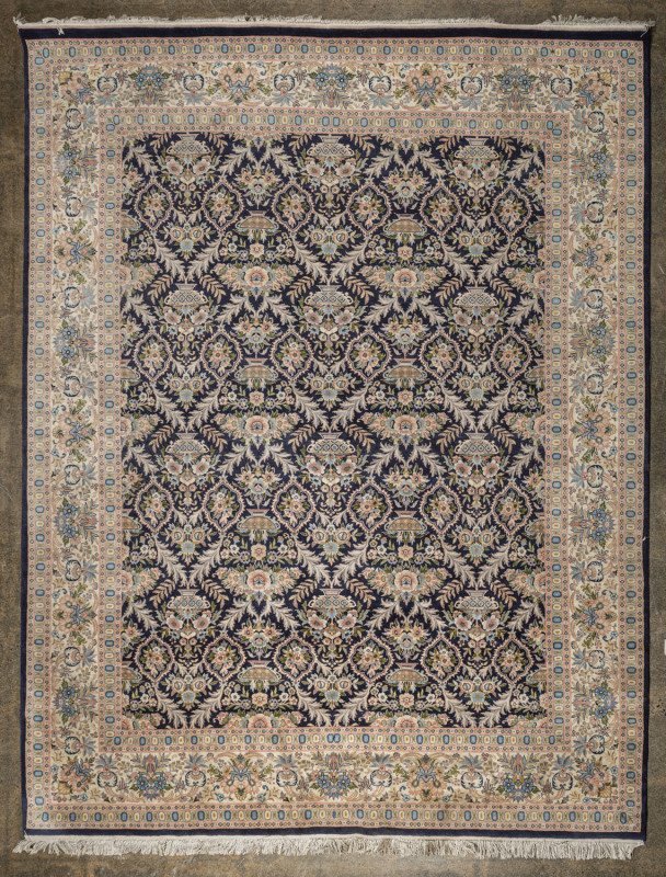 A Persian patterned hand-woven rug with floral motif on blue and cream ground, North Indian origin, 20th century, ​360 x 240cm