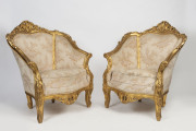 A pair of French ornate gilded armchairs, 20th century, 107cm high, 88cm across the arms