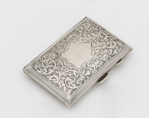 An antique English sterling silver card or cigarette case, attractively engraved with shield and foliate design, original gilt finish to the interior plus original fastening bands, made in Birmingham, circa 1913, 8 x 5cm, 46 grams