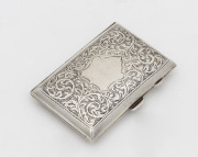 An antique English sterling silver card or cigarette case, attractively engraved with shield and foliate design, original gilt finish to the interior plus original fastening bands, made in Birmingham, circa 1913, ​8 x 5cm, 46 grams