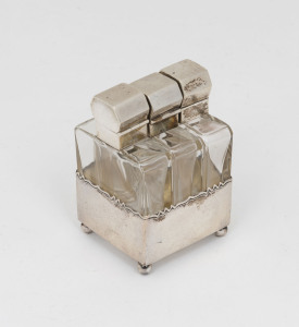 A rare Continental silver and crystal three bottle perfume set in original silver stand, early 20th century, stamped "800, TS", 7cm high