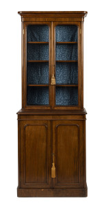 An antique English walnut two door bookcase of slim proportions, circa 1860, ​203cm high, 80cm wide, 42cm deep