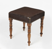 A Georgian English footstool with turned mahogany legs and brown leather upholstery, mid 19th century, 49cm high, 42cm wide, 42cm deep