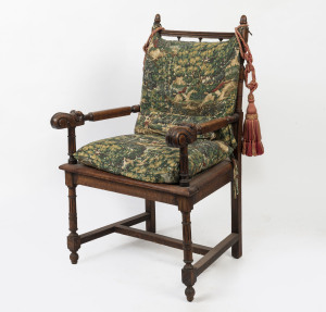 An antique oak armchair with green patterned linen upholstery, 19th century, 66cm across the arms