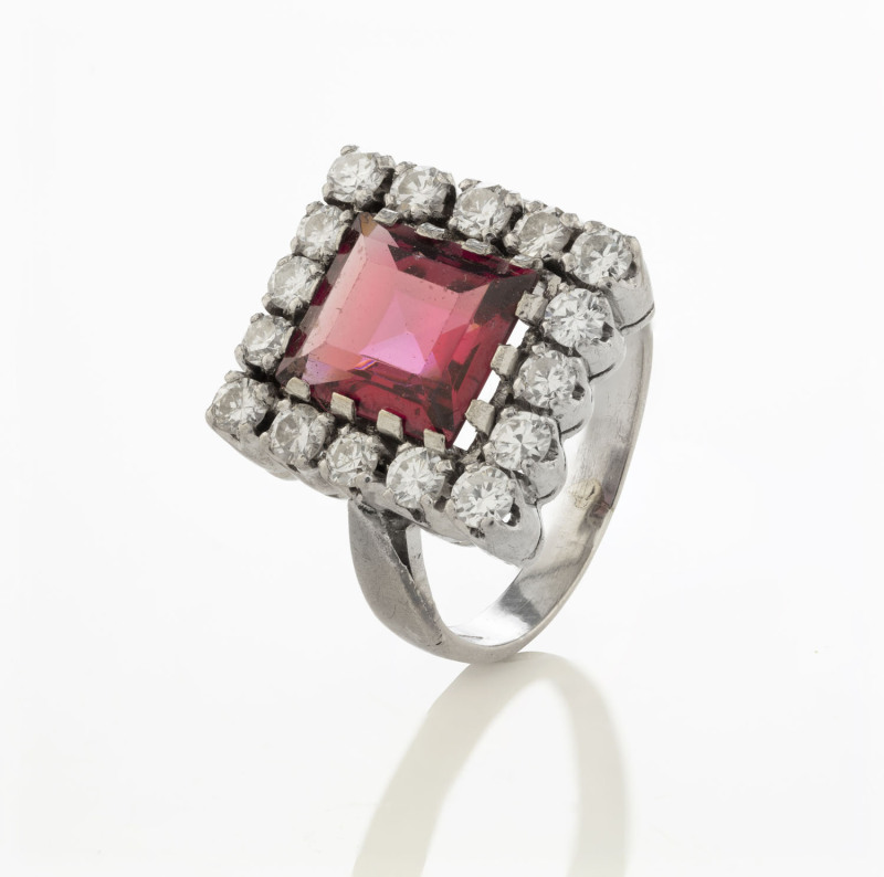 A 14ct white gold ring set with a 3ct garnet surrounded with 16 brilliant cut diamonds (0.8ct approximately, SI clarity), ​8.8 grams total, finger size O.