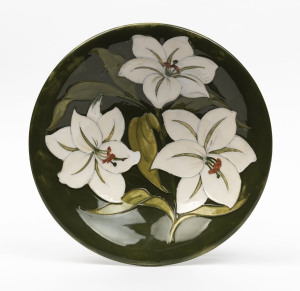 MOORCROFT "Lily" pattern bowl on green glazed ground, mid 20th century, stamped "Moorcroft, Made in England", 25cm diameter