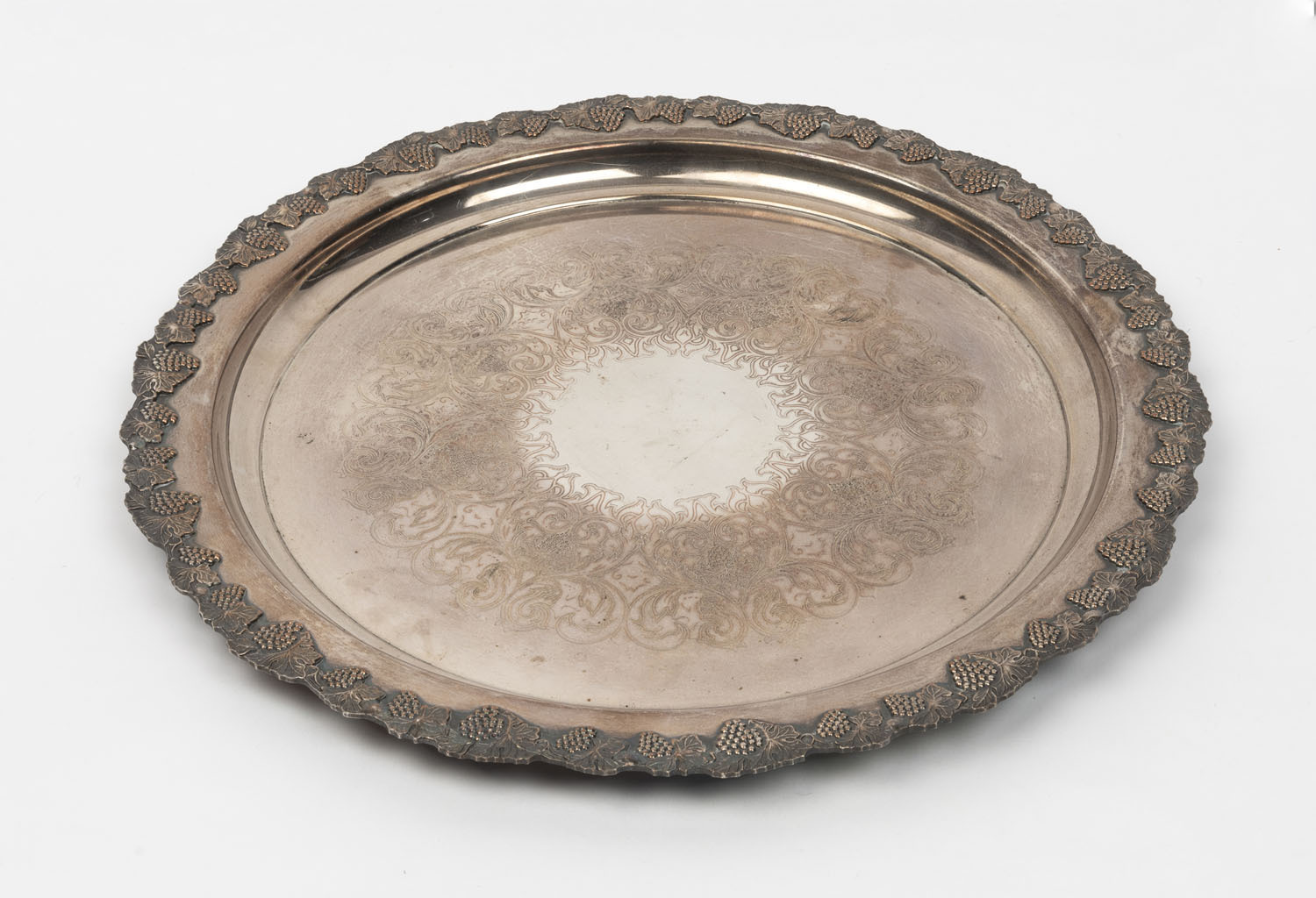 A vintage silver plated serving platter, with a decorative grape and ...