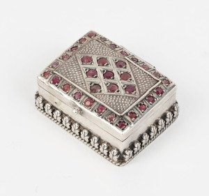 A Persian sterling silver pill box studded with rubies, 4.2cm wide