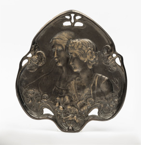 A cast and patinated Art Nouveau style dressing table tray with floral decoration and depicting two young ladies, 20th century, 21cm wide