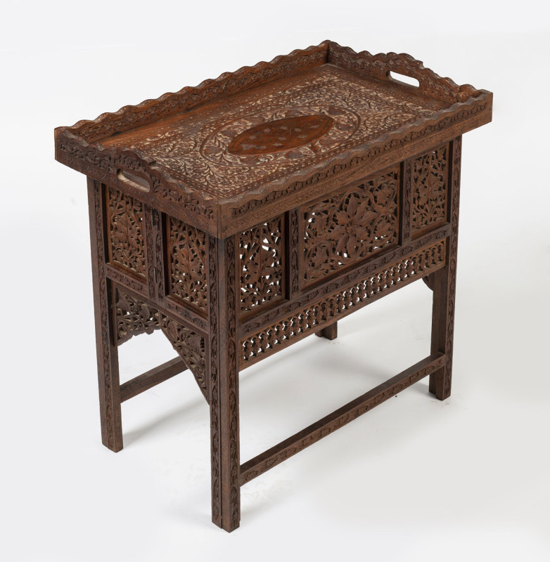 An Indian folding occasional table with ornate carved lift-top tray, 20th century, ​57cm high, 62cm wide, 39cm deep