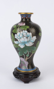 A Chinese cloisonne vase decorated with brass wire and coloured enamel depicting various flowers and a butterfly, standing on a timber base, 20th century, 21cm high