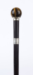 An antique English walking stick, turned tiger's eye handle, sterling silver collar, ebony shaft and horn ferrule, 19th century, 86cm high