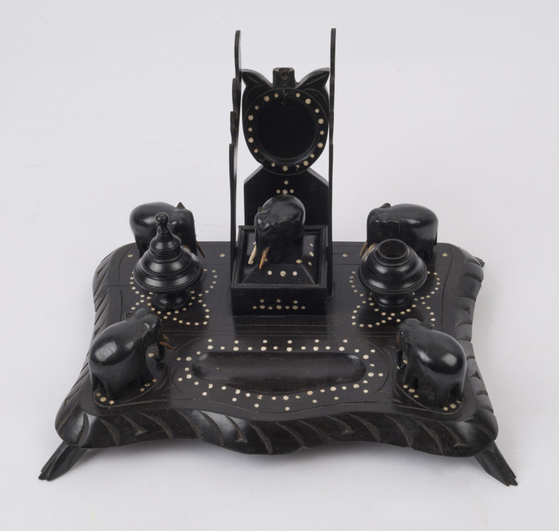 An Indian carved ebony desk set with ivory dot inlay and carved elephants, 19th century, 19cm high, 30cm wide, 21cm deep