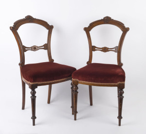 A pair of antique English carved walnut dining chairs with burgundy velvet upholstery, circa 1895