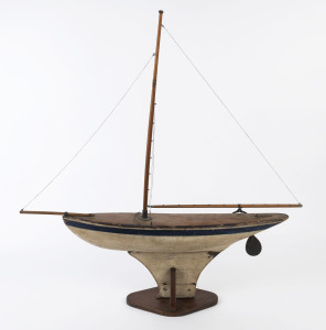 An antique pond yacht on stand, late 19th century, ​92cm high, 94cm long