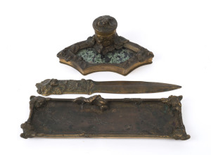 A French three piece bronze desk set comprising of a letter opener, inkwell and pen tray, by A. MARIONNET, circa 1895, with additional retailer's label verso, the letter opener 30cm long