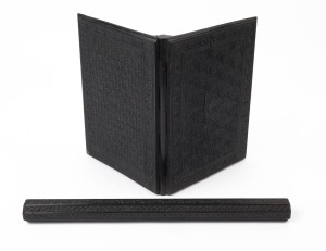 An Anglo-Indian carved ebony folding blotter book and an octagonal floral carved ebony ruler, 19th century, (2 items), the ruler 41.5cm wide