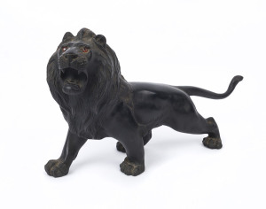 A Japanese bronze lion statue, Meiji period, 19th century, seal mark to underside, ​18cm high, 31cm long