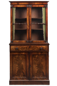 An antique dwarf bookcase secretaire, finely selected flame mahogany fronts with fold out writing slope and compartments, early 19th century, 177cm high, 85cm wide, 40cm deep