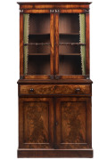 An antique dwarf bookcase secretaire, finely selected flame mahogany fronts with fold out writing slope and compartments, early 19th century, ​177cm high, 85cm wide, 40cm deep