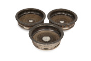 Three antique Sheffield plate bottle coasters, 19th century, 5cm high, 15.5cm diameter