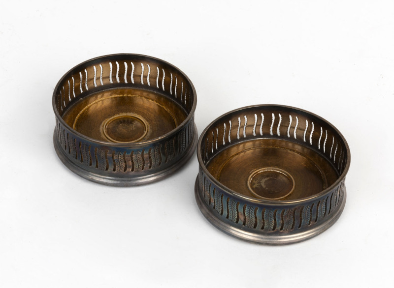 A pair of silver plated wine bottle coasters, early 20th century