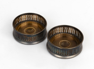 A pair of silver plated wine bottle coasters, early 20th century