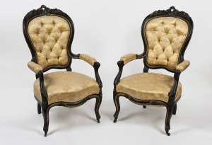 A pair of antique parlour chairs, carved and ebonised timber frames with gilt highlights and button back brocade upholstery, circa 1870, 67cm across the arms