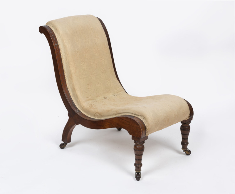 An antique nursing chair, carved walnut, circa 1890