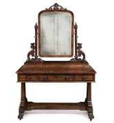 An impressive antique English dressing table with fine cuts of flame mahogany and ornately carved embellishments, circa 1855, 186cm high, 122cm wide, 64cm deep