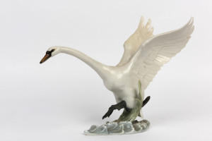 HUTSCHENREUTHER German porcelain swan statue, 20th century, blue factory mark to base, 22cm high, 28cm long