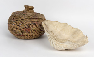 A giant clam shell together with a woven tribal basket, (2 items), the shell 28cm across