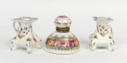 A pair of floral porcelain candle holders together with a continental porcelain inkwell, 19th and 20th century, (3 items), the inkwell 11cm high, 10cm diameter