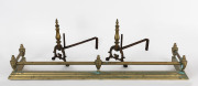 An antique brass fire curb and pair of brass fire dogs, 19th/20th century, 120cm wide