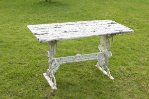 A vintage garden table, cast metal and timber with white painted finish, 68cm high, 121cm wide, 61cm deep